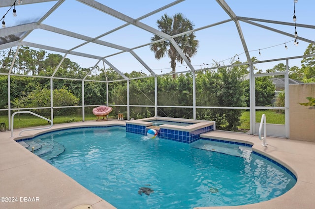 view of pool featuring a patio, a lanai, and an in ground hot tub