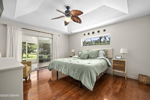 10 Pointing Pl, Palm Coast, FL 32164 - bedroom with access to exterior, a raised ceiling, multiple windows, and wood finished floors