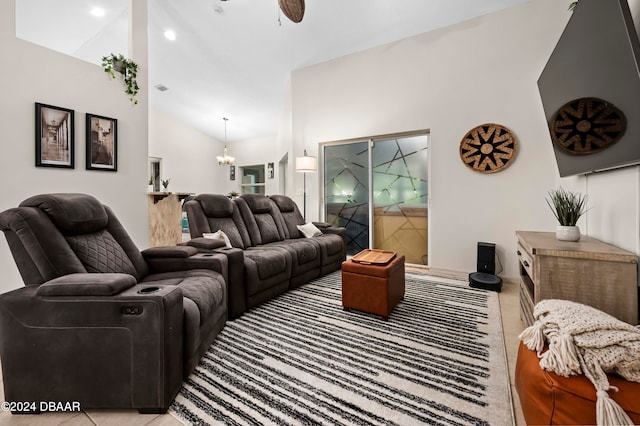 living room with vaulted ceiling, light tile patterned floors, and ceiling fan with notable chandelier