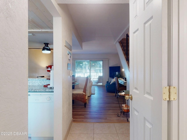 hall featuring light tile patterned floors