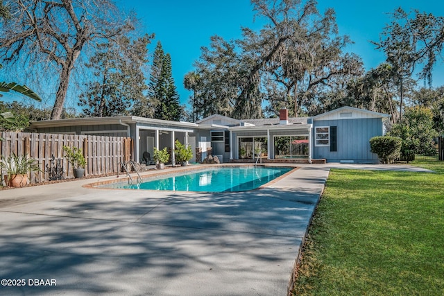 view of pool featuring a lawn and a patio area