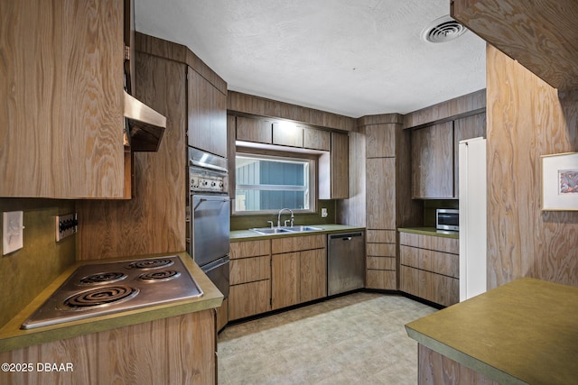 kitchen featuring sink, a textured ceiling, and appliances with stainless steel finishes