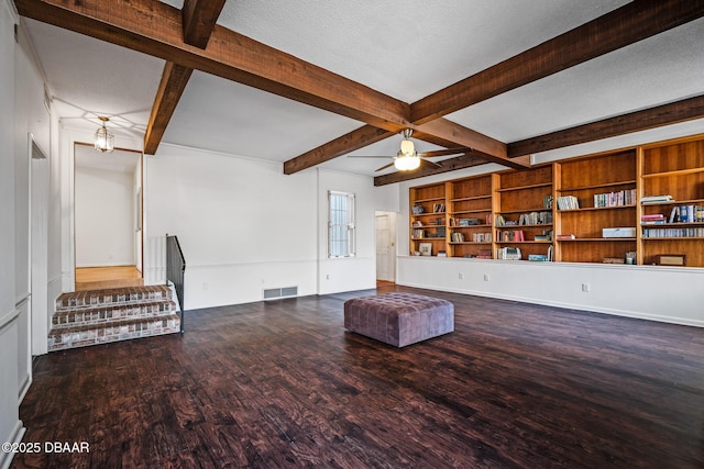 unfurnished living room with hardwood / wood-style floors, beam ceiling, a textured ceiling, and ceiling fan