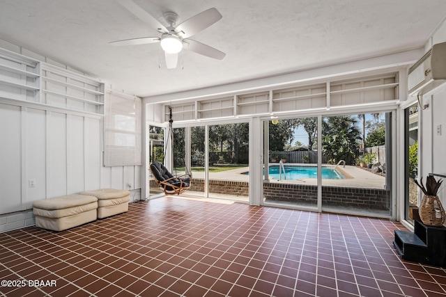 interior space featuring ceiling fan and a healthy amount of sunlight