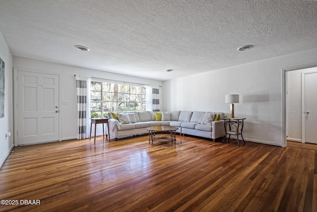 unfurnished living room featuring dark hardwood / wood-style flooring and a textured ceiling