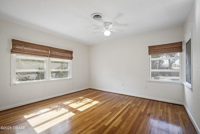 empty room with ceiling fan and hardwood / wood-style floors