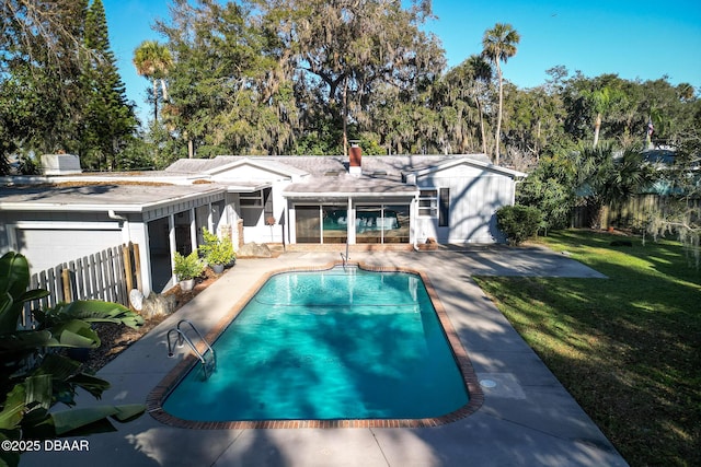 view of swimming pool with a patio area and a lawn