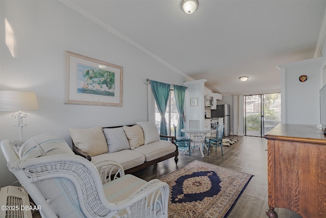 43 Jacaranda Cay Ct Unit 430, New Smyrna Beach, FL 32169 - living room featuring vaulted ceiling, ornamental molding, wood finished floors, and a wealth of natural light