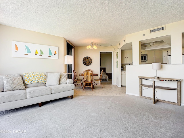 living area featuring a notable chandelier, visible vents, light tile patterned floors, and a textured ceiling