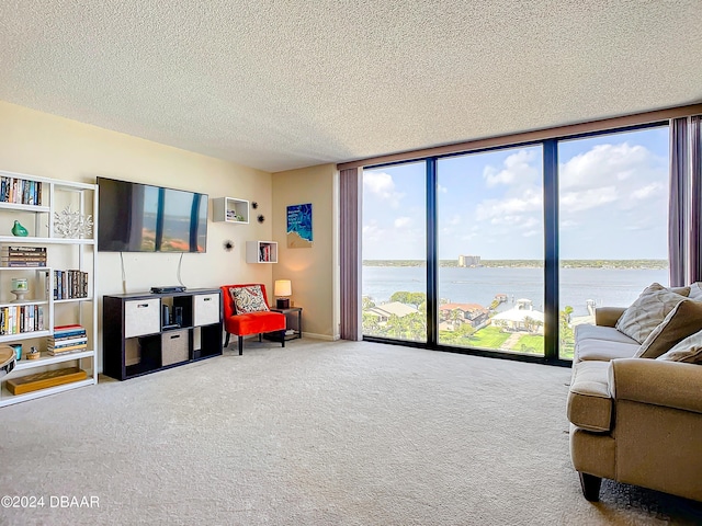 carpeted living room featuring floor to ceiling windows and a textured ceiling