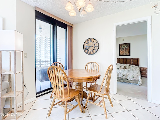 dining space with light tile patterned floors, a textured ceiling, and a chandelier