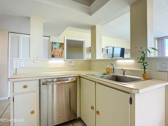 kitchen featuring a sink, a textured ceiling, light tile patterned flooring, light countertops, and dishwasher