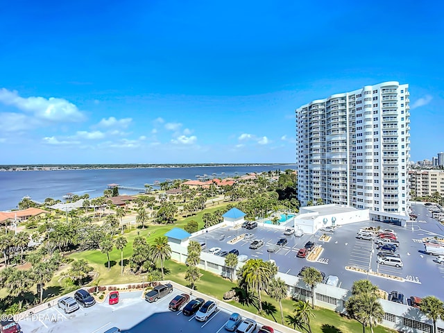 drone / aerial view featuring a city view and a water view