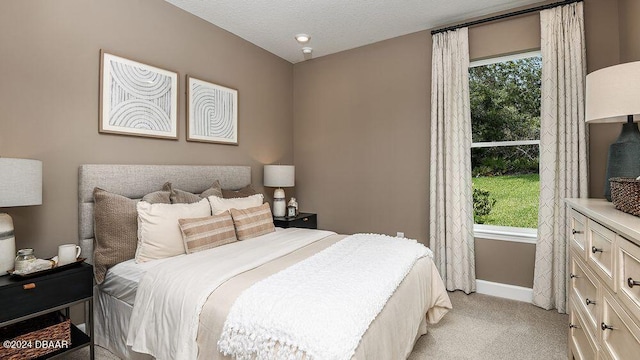 carpeted bedroom with a textured ceiling