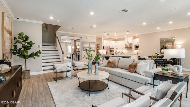 living room with crown molding and light hardwood / wood-style flooring