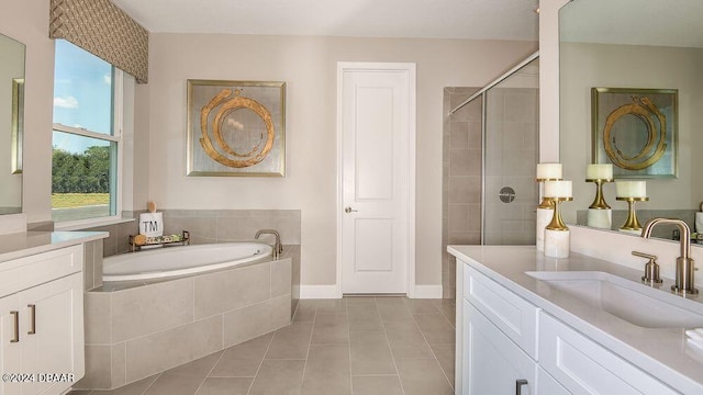 bathroom featuring tile patterned flooring, shower with separate bathtub, and vanity