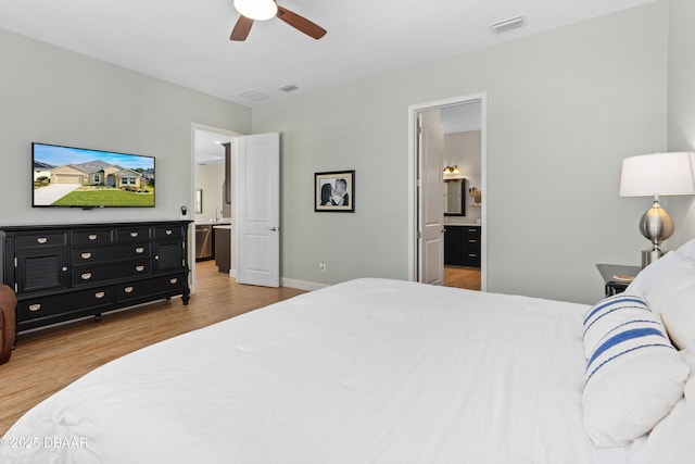6871 Forkmead Ln, Port Orange, FL 32128 - bedroom featuring wood finished floors, ensuite bathroom, baseboards, and a ceiling fan