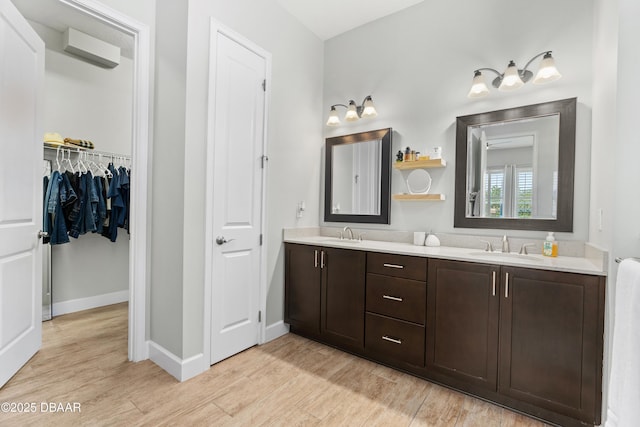 6871 Forkmead Ln, Port Orange, FL 32128 - full bath featuring double vanity, wood finished floors, baseboards, and a walk in closet