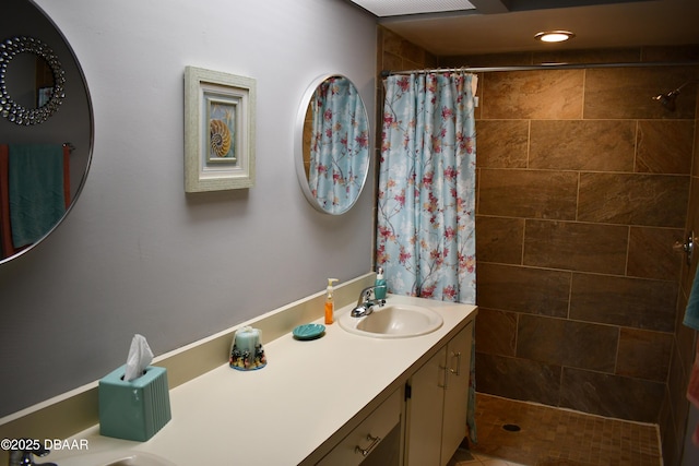 full bathroom with vanity and a tile shower