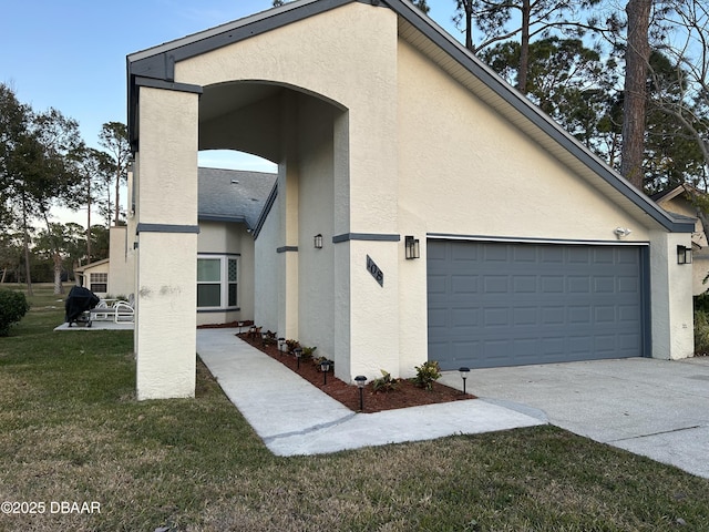 view of side of home featuring a garage and a lawn