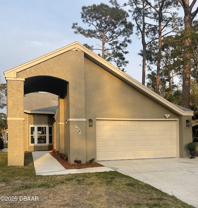 view of front of house featuring concrete driveway and stucco siding