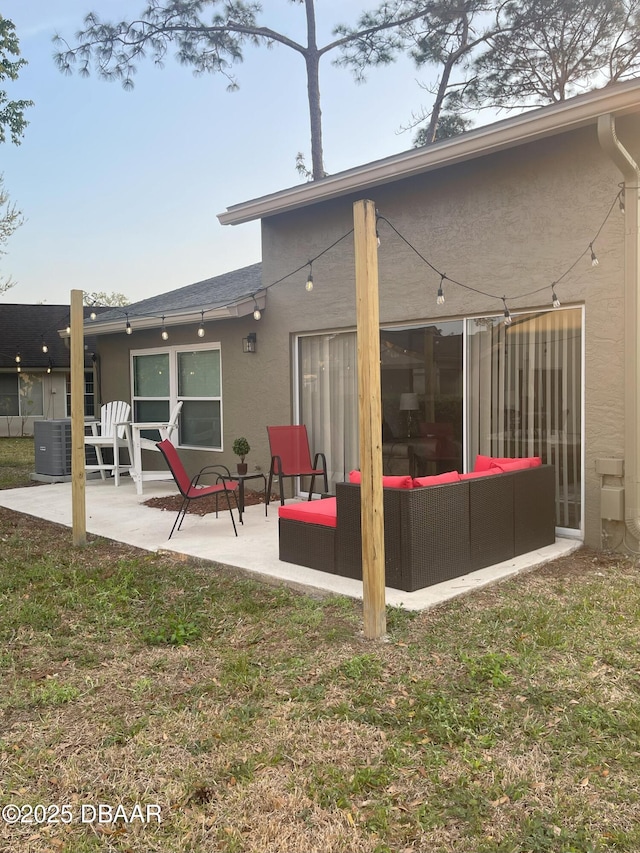 rear view of property with a patio, cooling unit, an outdoor living space, a yard, and stucco siding