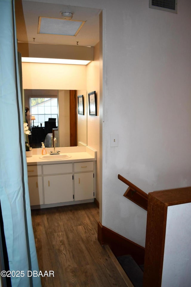 bathroom featuring visible vents, vanity, and wood finished floors