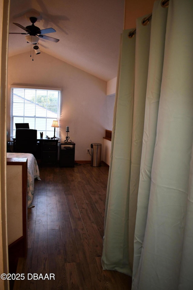 bedroom with dark wood-type flooring and vaulted ceiling