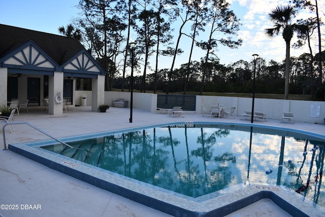 community pool featuring a patio area, a ceiling fan, and fence