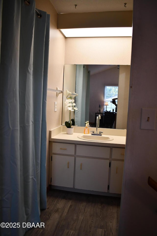 full bathroom with vanity and wood finished floors