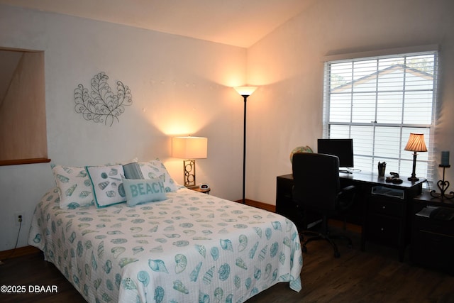 bedroom featuring vaulted ceiling and wood finished floors