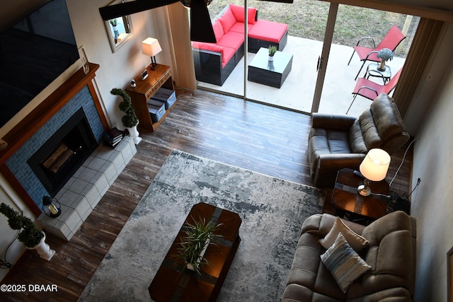 living area featuring wood finished floors and a tile fireplace