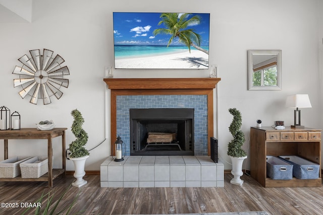108 Shoal Creek Cir, Daytona Beach, FL 32114 - room details with baseboards, wood finished floors, and a tile fireplace