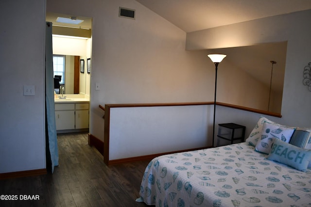 bedroom with visible vents, a sink, baseboards, lofted ceiling, and dark wood-style flooring