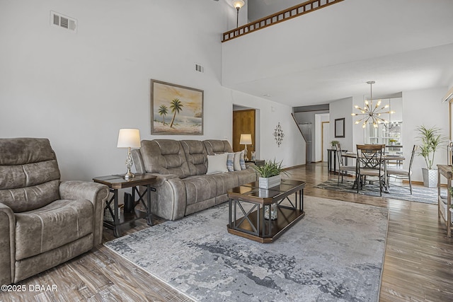 108 Shoal Creek Cir, Daytona Beach, FL 32114 - living room featuring visible vents, wood finished floors, and a notable chandelier