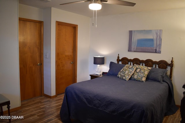 bedroom featuring a ceiling fan, visible vents, wood finished floors, and baseboards