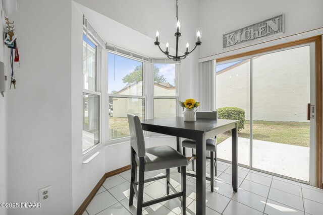 108 Shoal Creek Cir, Daytona Beach, FL 32114 - dining room with a chandelier, baseboards, light tile patterned floors, and plenty of natural light