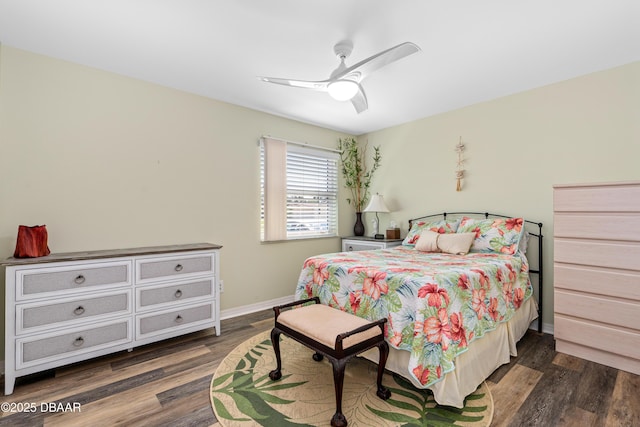 bedroom with a ceiling fan, wood finished floors, and baseboards