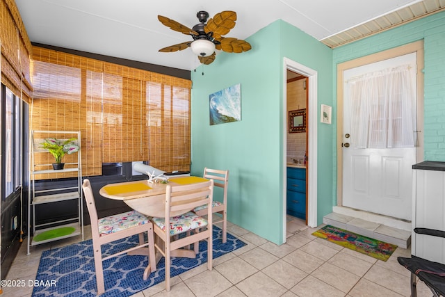 tiled dining area with a ceiling fan and a sink