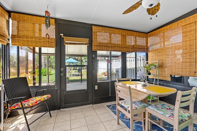 sunroom / solarium with a healthy amount of sunlight and a ceiling fan