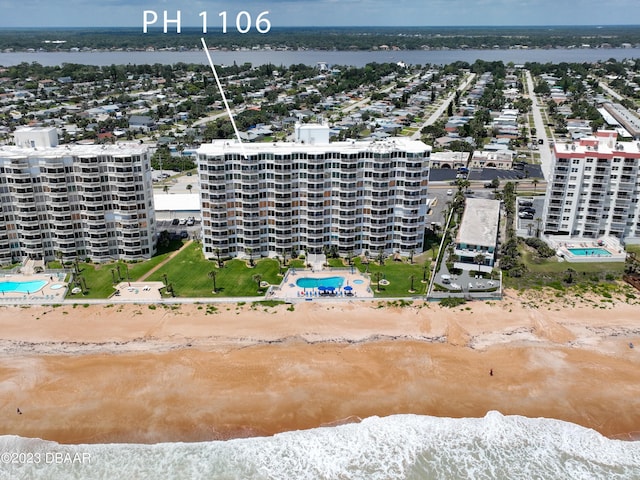 drone / aerial view with a water view and a view of the beach