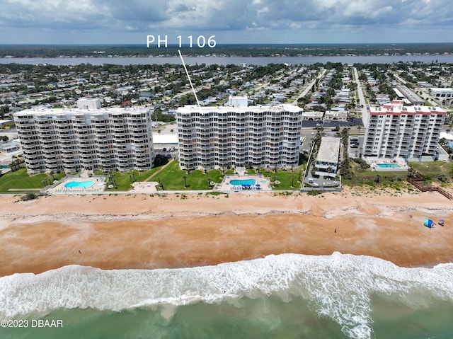 aerial view with a water view and a view of the beach