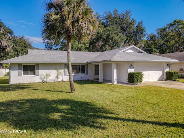 ranch-style home with a garage and a front lawn