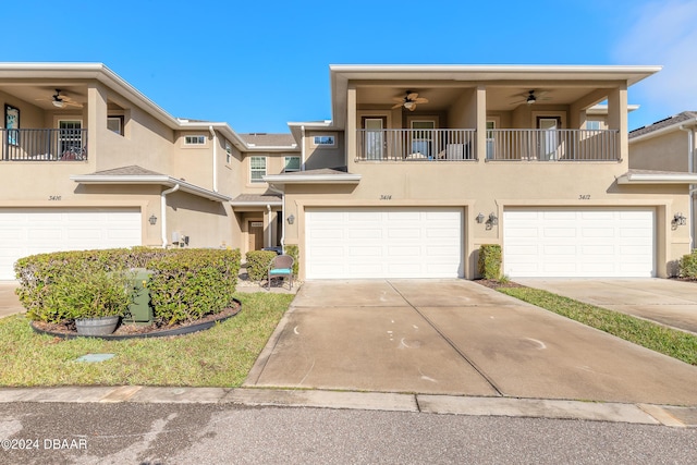 townhome / multi-family property with ceiling fan and a balcony