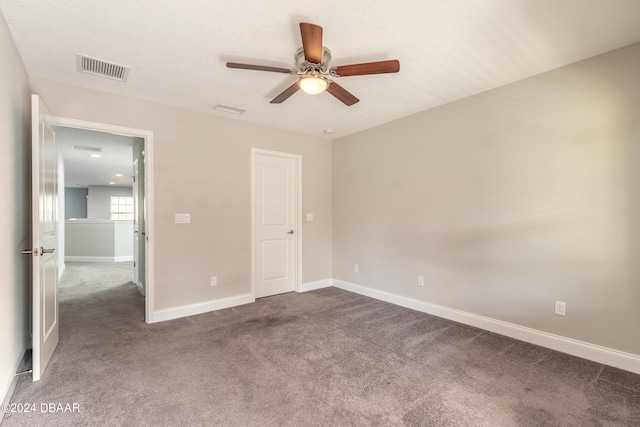 unfurnished bedroom with carpet flooring, ceiling fan, and a textured ceiling