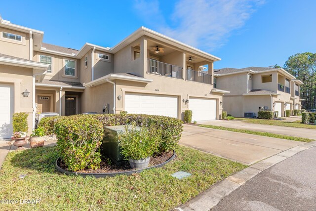 multi unit property with ceiling fan, a garage, and a balcony