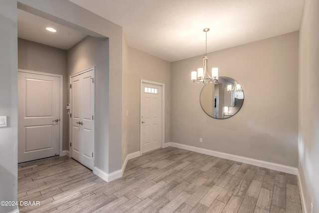 foyer featuring a notable chandelier and light hardwood / wood-style floors