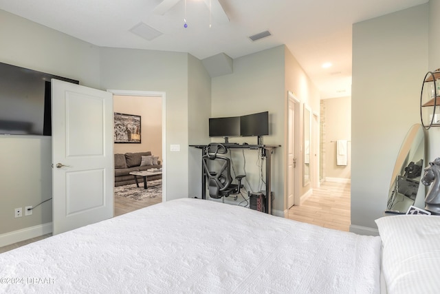 bedroom with ensuite bath, ceiling fan, and light wood-type flooring