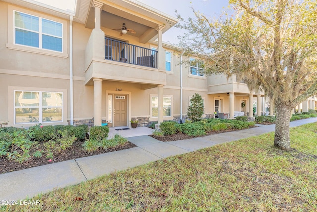 multi unit property featuring a balcony and ceiling fan