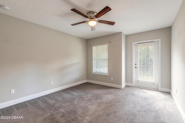 spare room with ceiling fan, carpet floors, and a textured ceiling